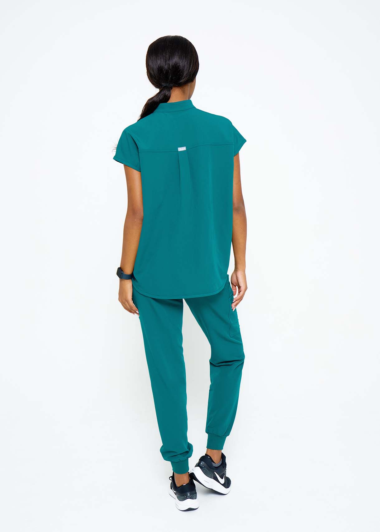 Model wearing scrubs.