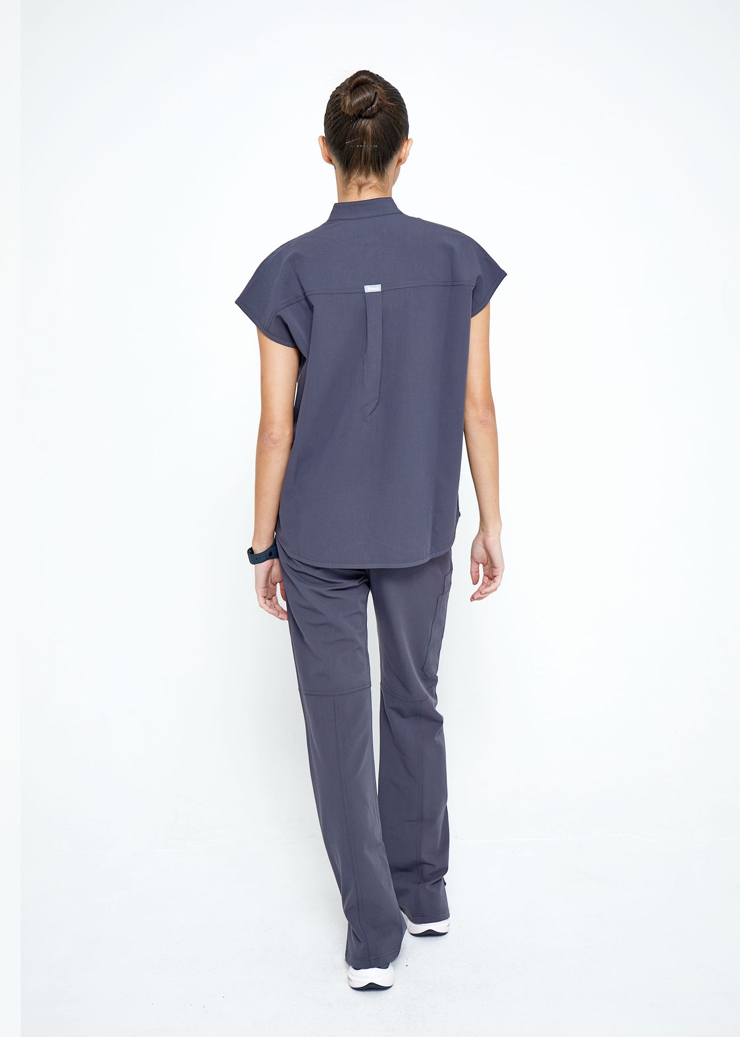 Model wearing scrubs.