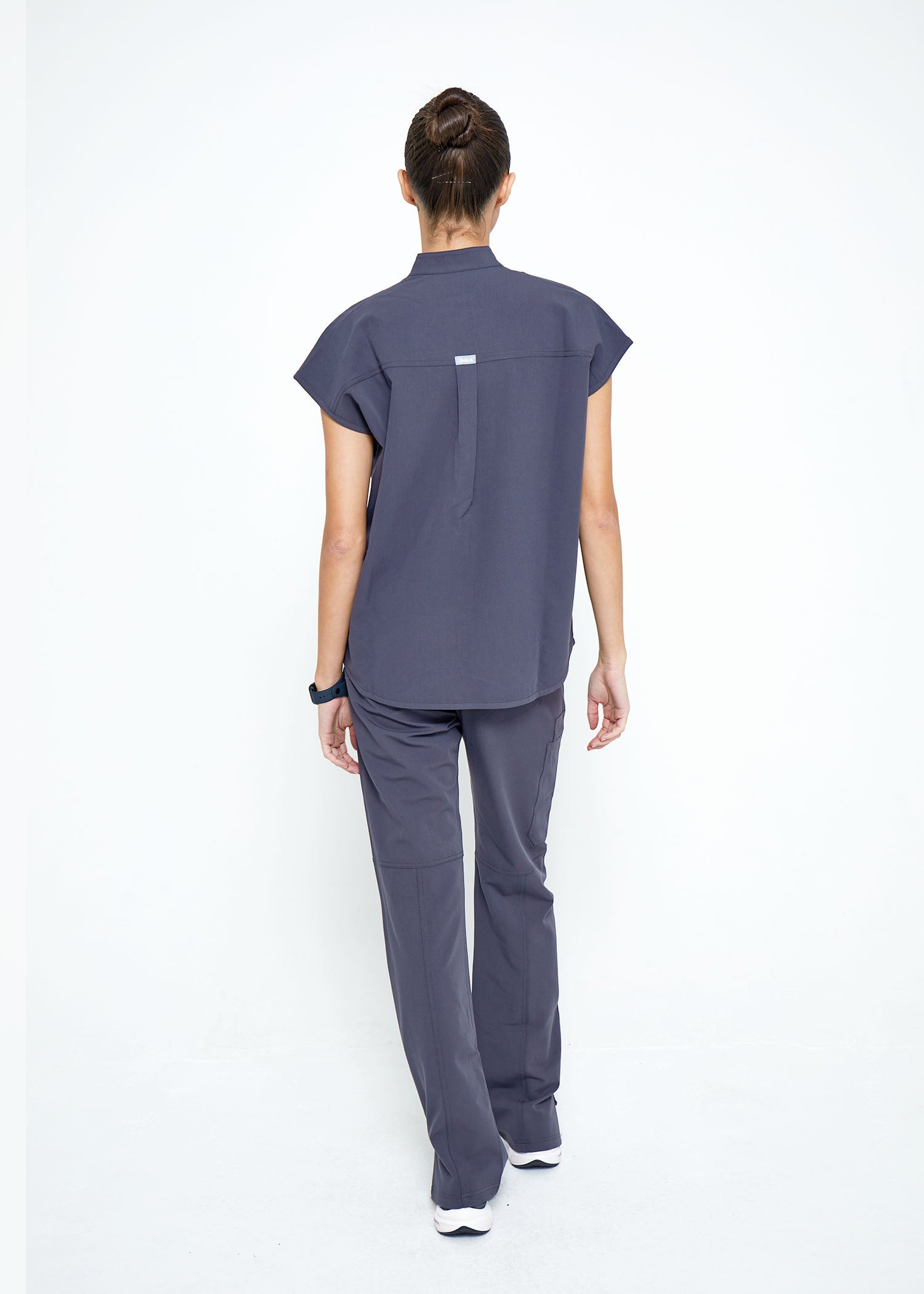 Model wearing scrubs.