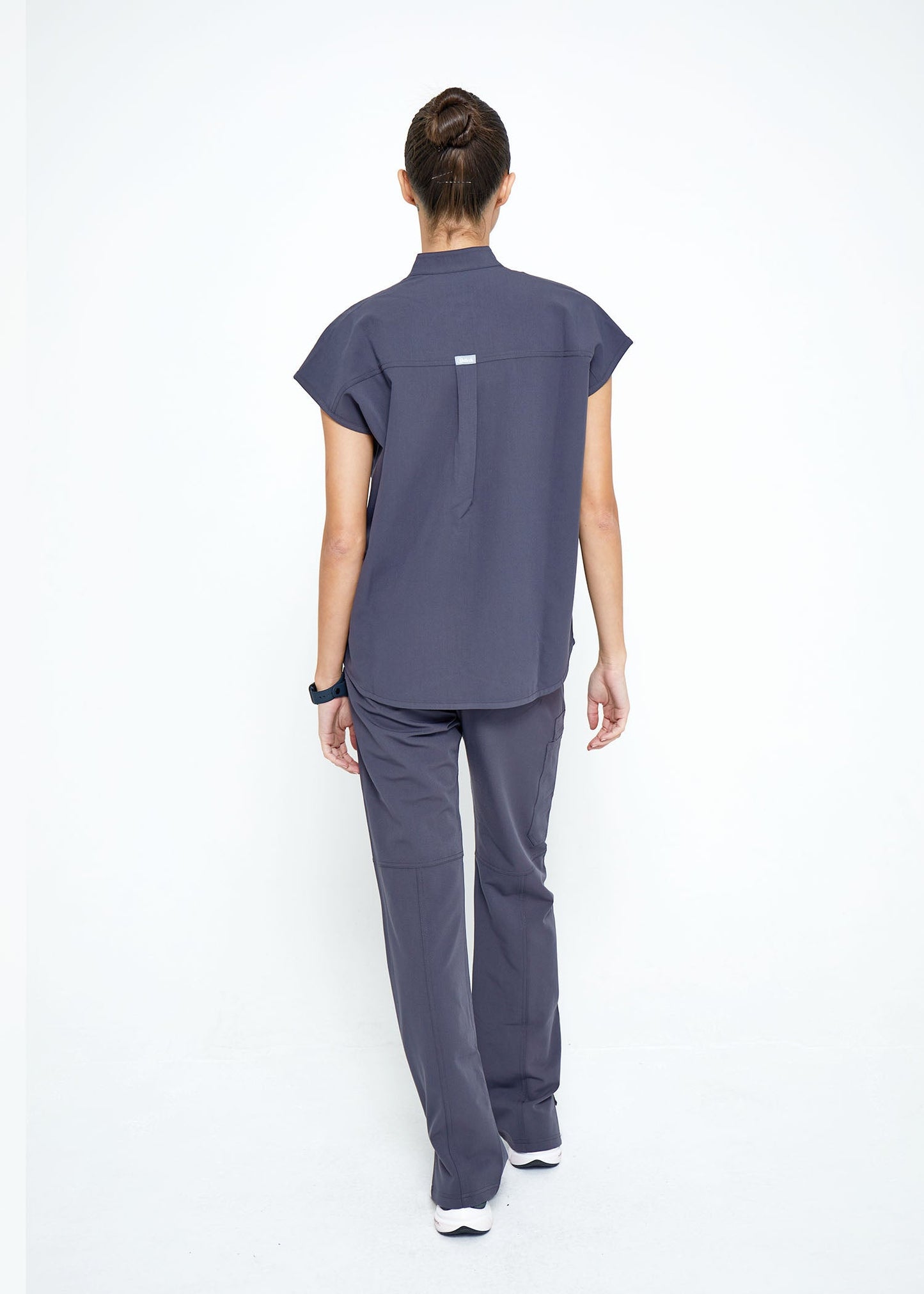 Model wearing scrubs.