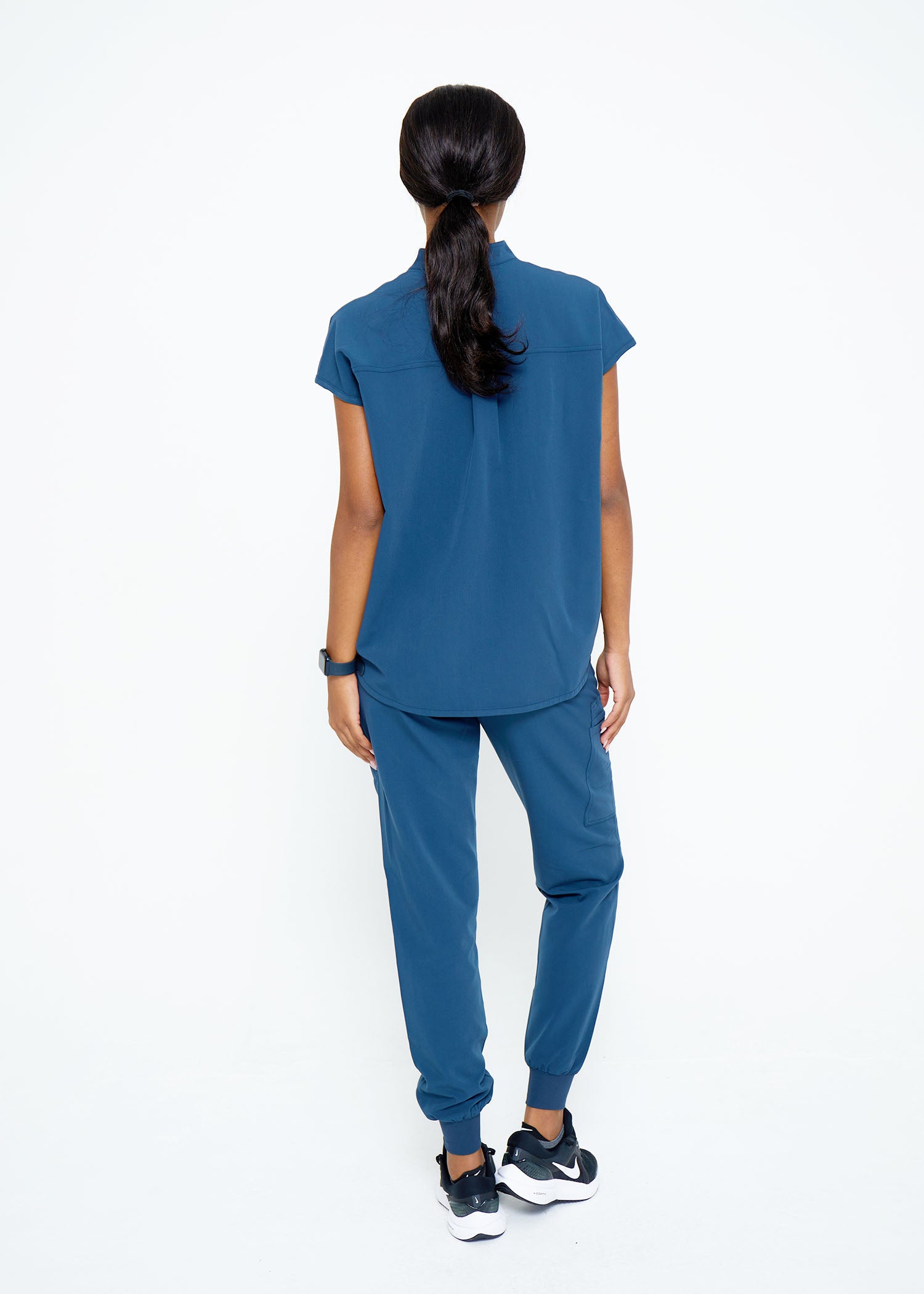Model wearing scrubs.