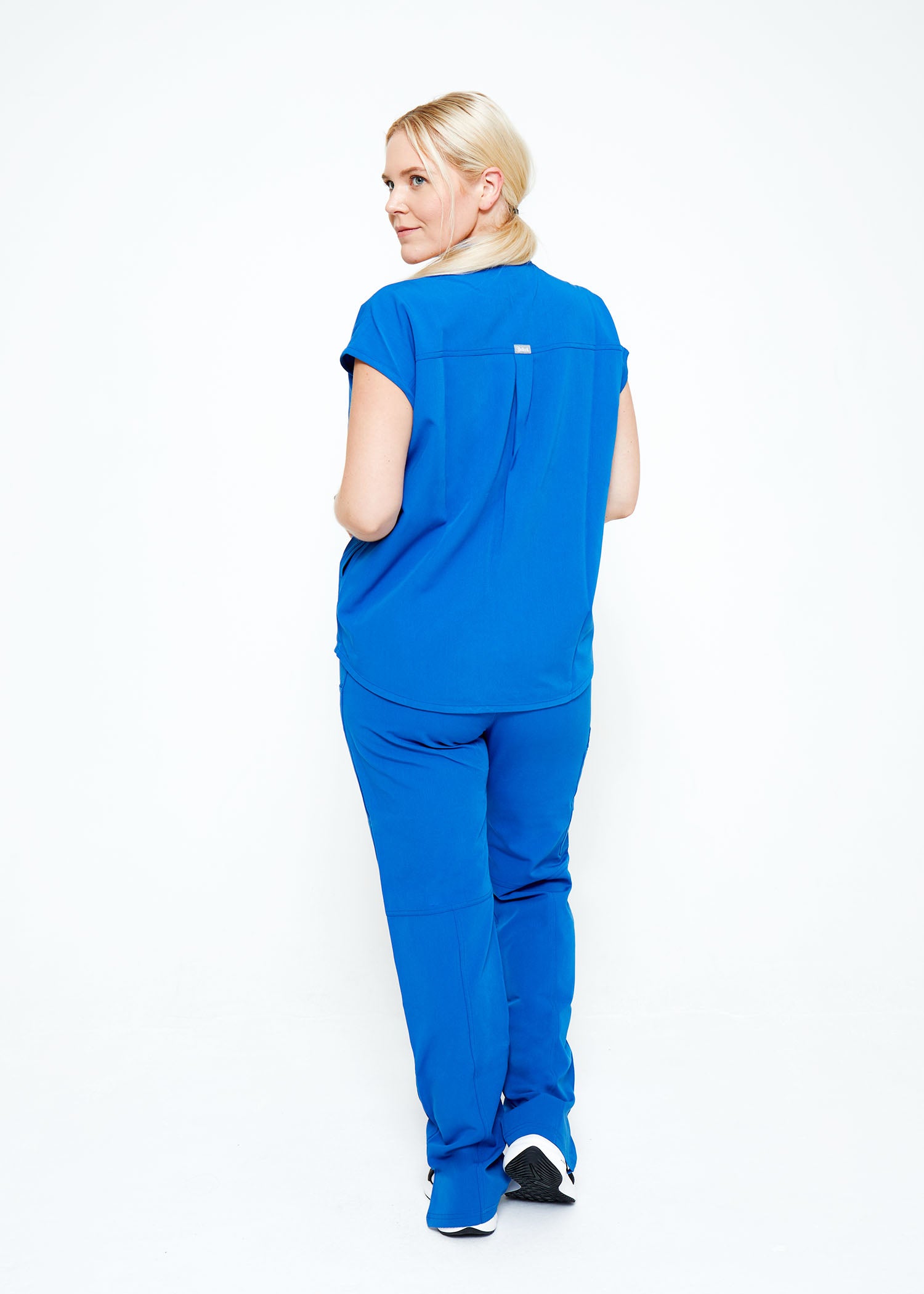 Model wearing scrubs.