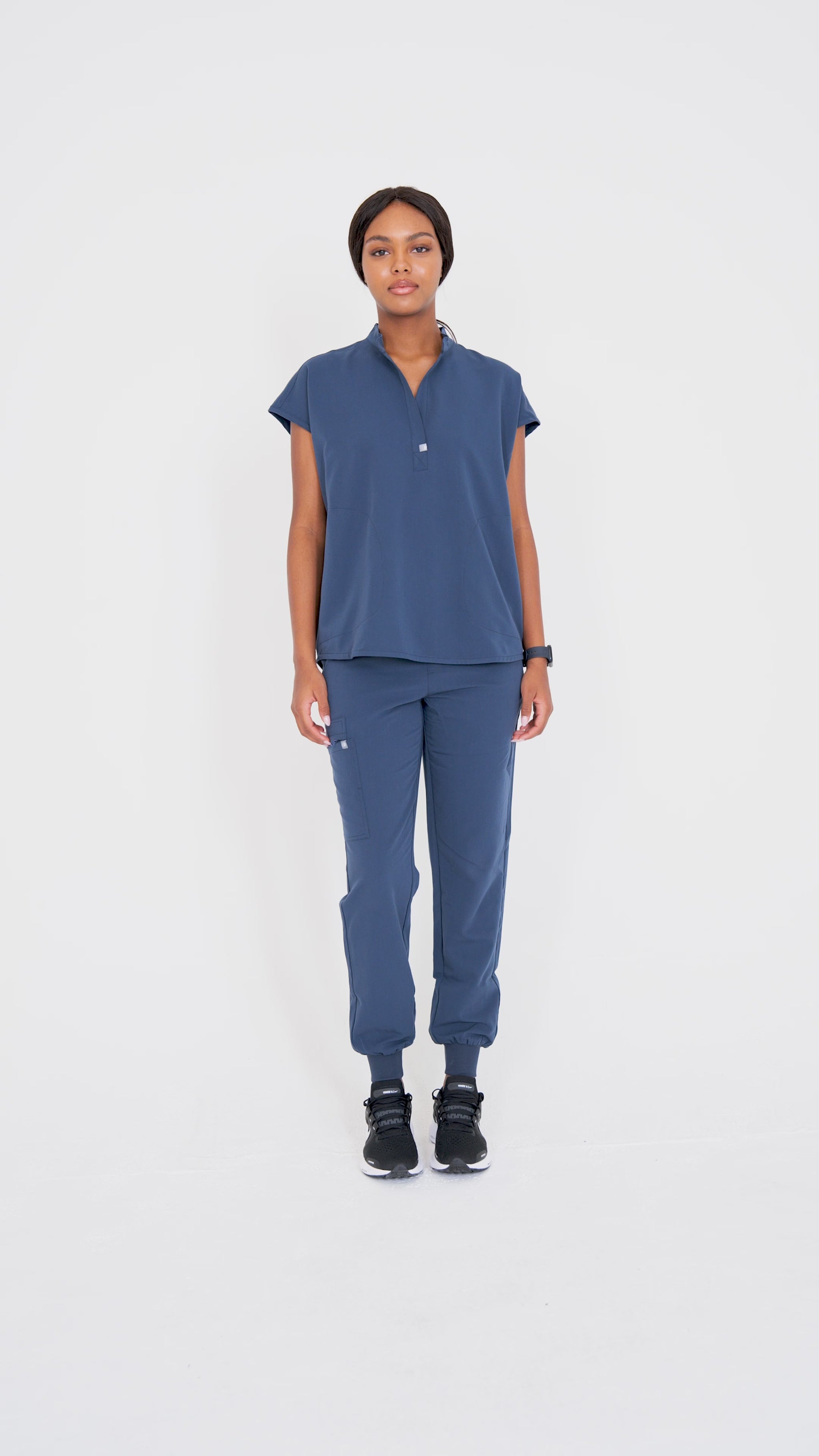 Video of model wearing scrubs and walking.